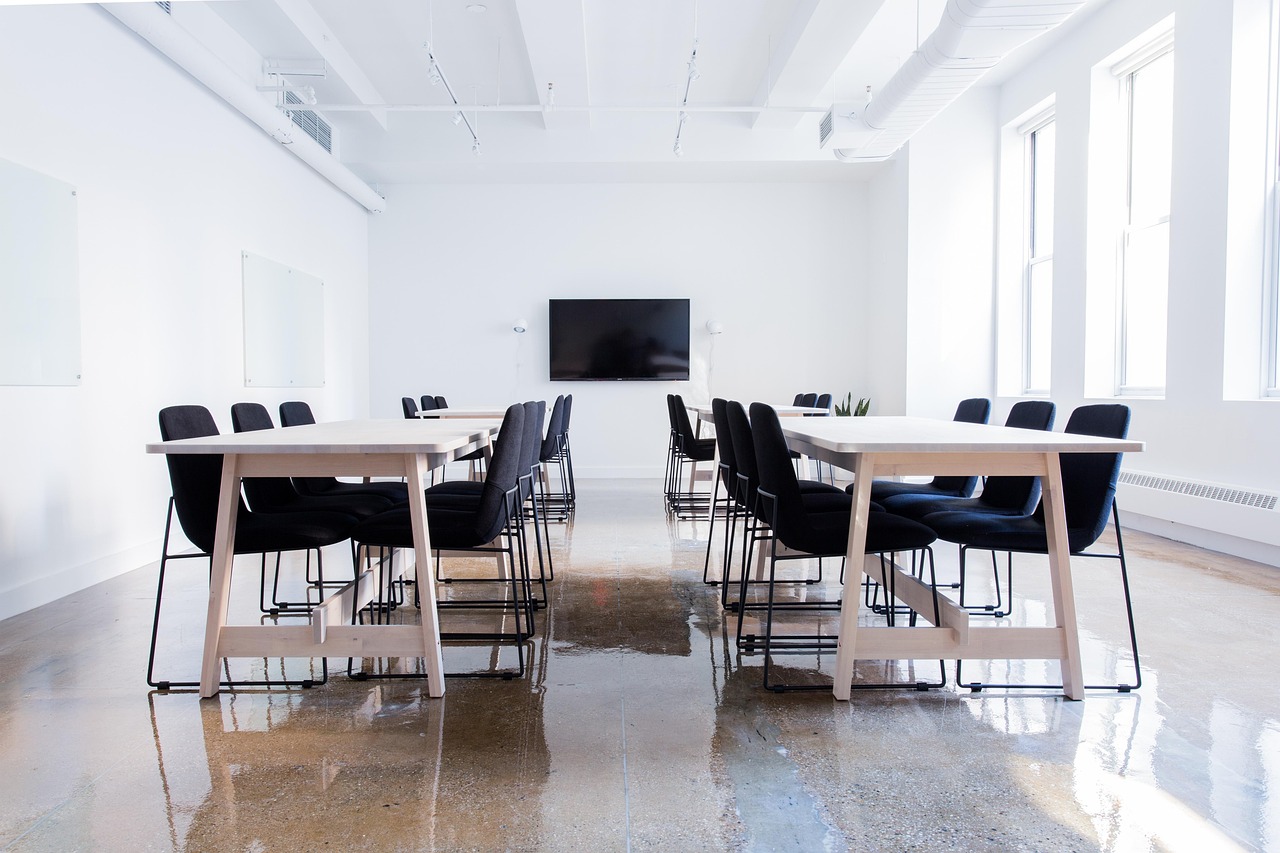 Finished wooden tables in a commercial conference room