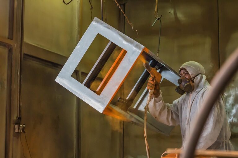 Powder coating sprayed onto a metal part before it enters the powder coating oven to cure
