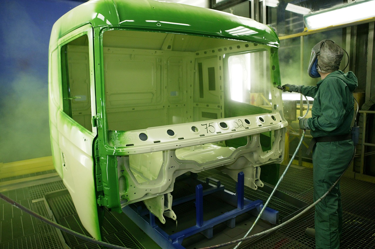The powder coating process applied to metal in a workshop